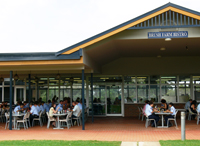Outside seating area of onsite bistro, showing people eating at seats and tables.