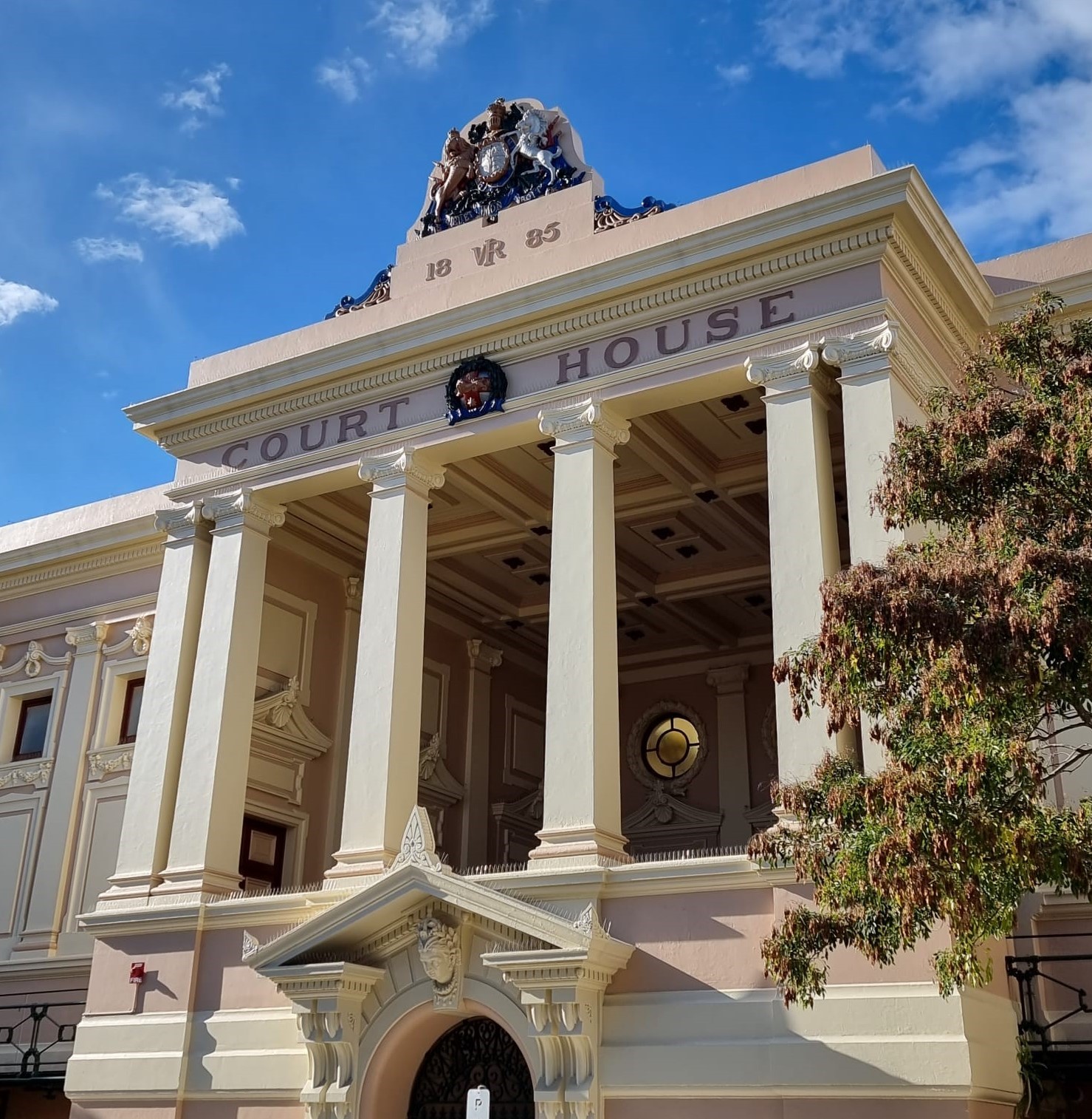 Newtown Courthouse against a bright blue sky