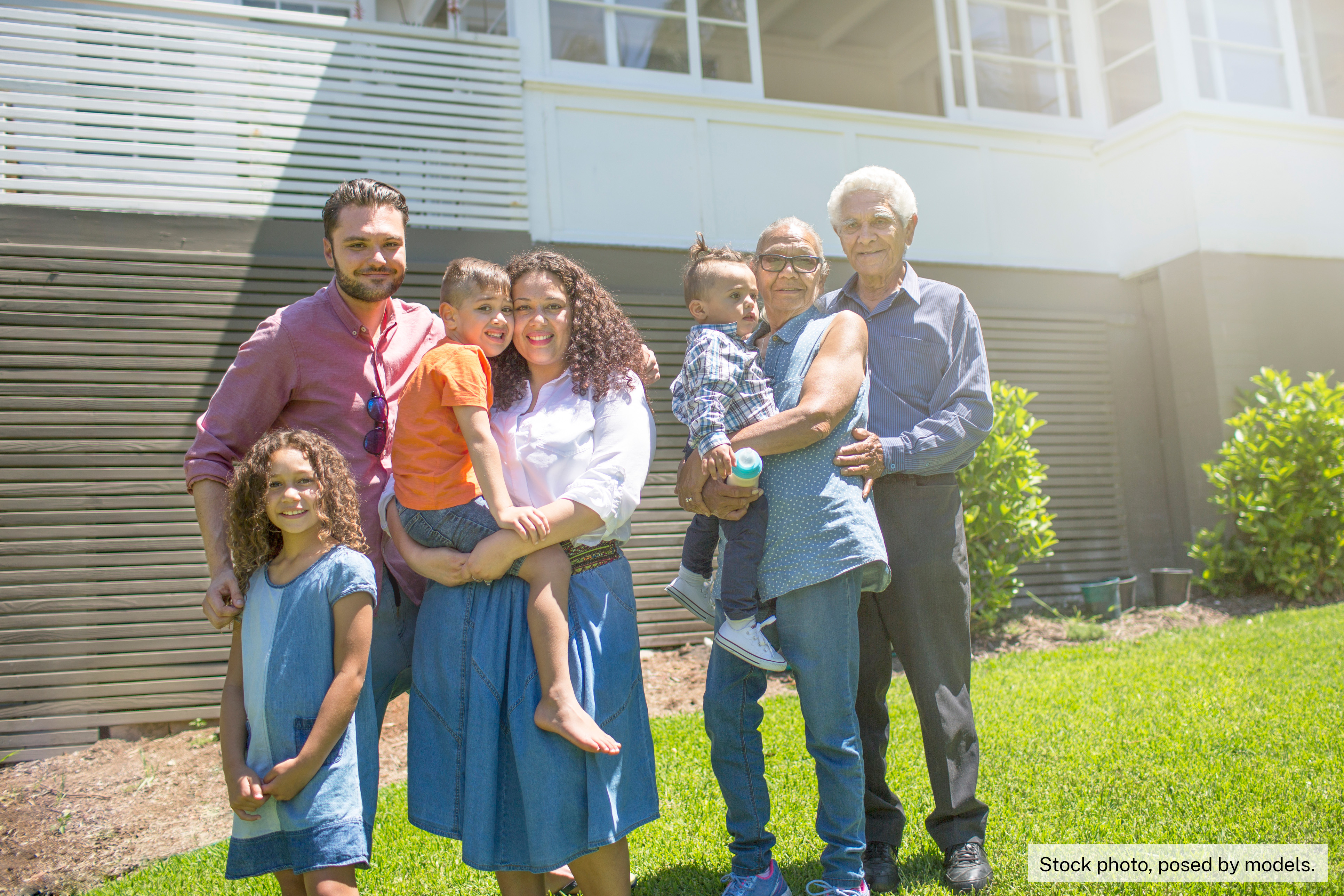 multi-generational Aboriginal family outside their home 
