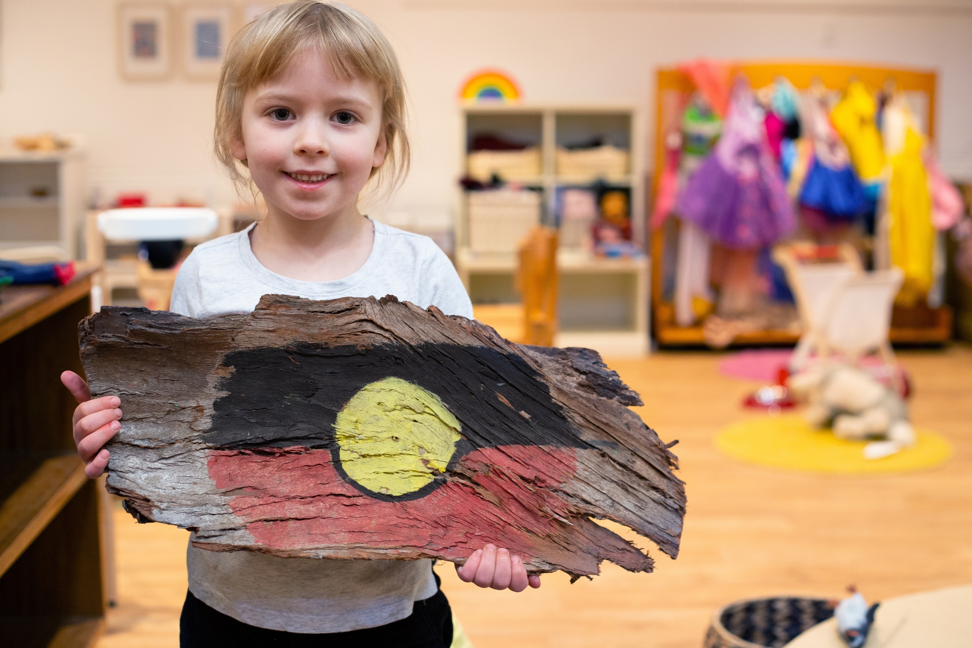 Little child holding Aboriginal flag