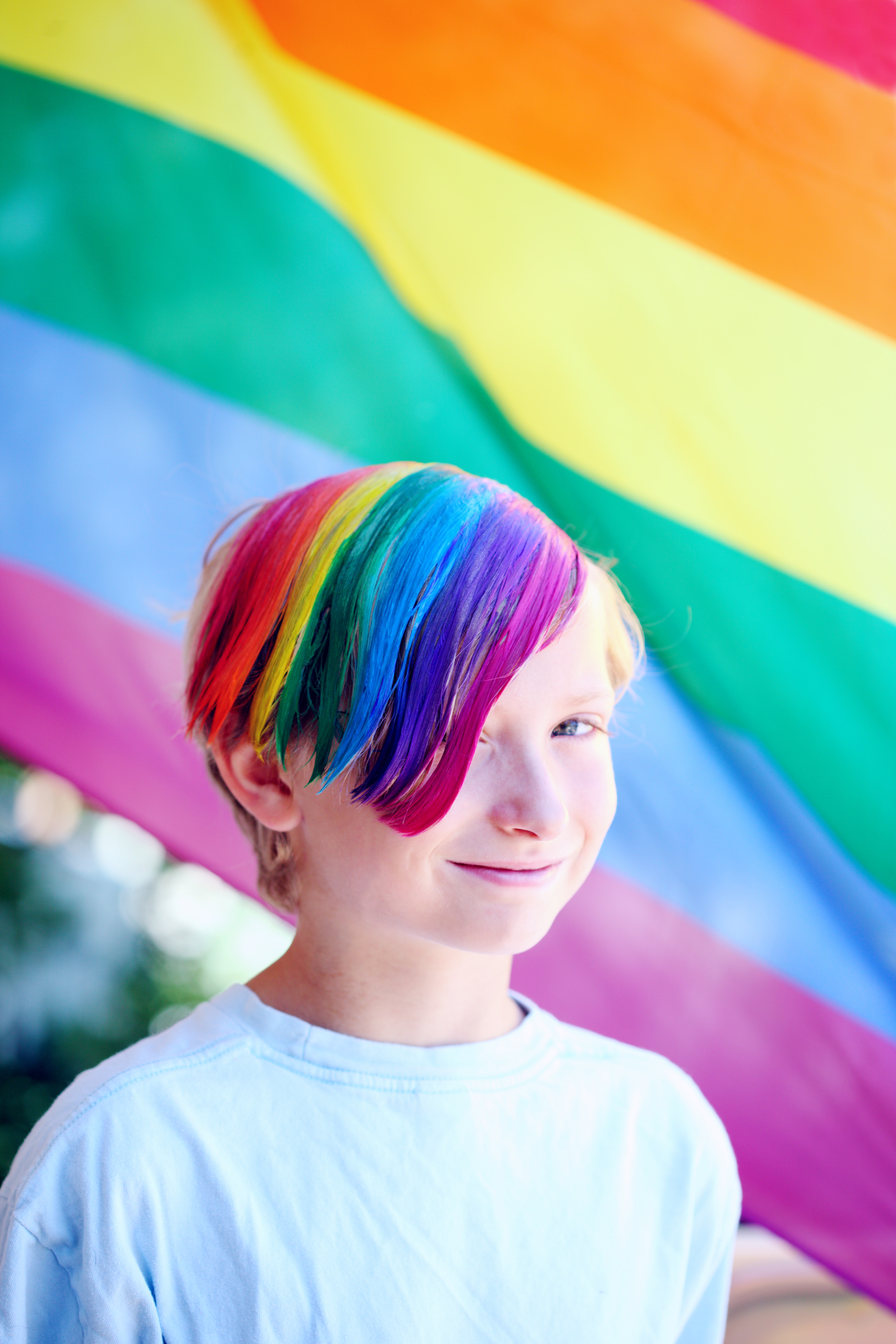 Rainbow haired person smiling