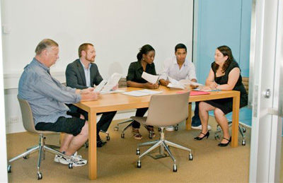 Group of people deliberating at table