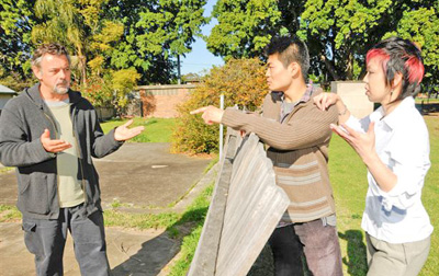 Man arguing with couple over fence