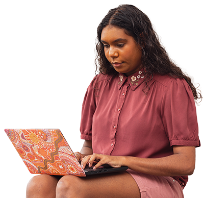 Image of a girl sitting and using a laptop.